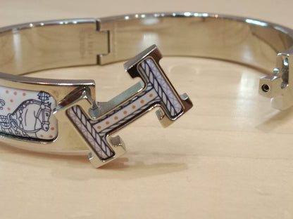 Hermes Clic H Bracelet in the "Grand Apparat Remix" Pattern White Enamel Printed Band Palladium-Plated Hardware GM Size